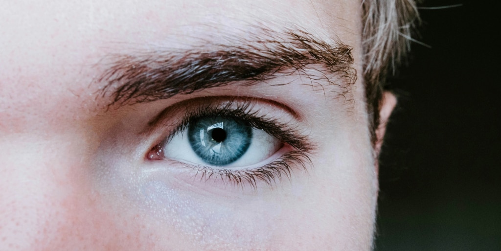 A close-up shot of a young man’s left eye, showcasing its grey eye colour.