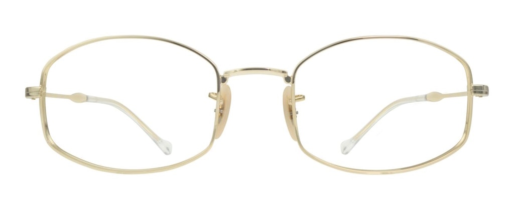 A gold metal glasses frame with lenses that are oval but slightly angular