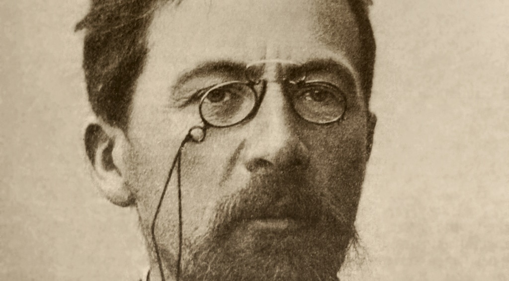 A black and white photo of Russian writer Anton Chekov wearing pince-nez glasses