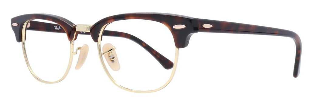 A pair of Clubmaster glasses with a mix of Havana acetate and gold metal with gold rivets, positioned at an angle.