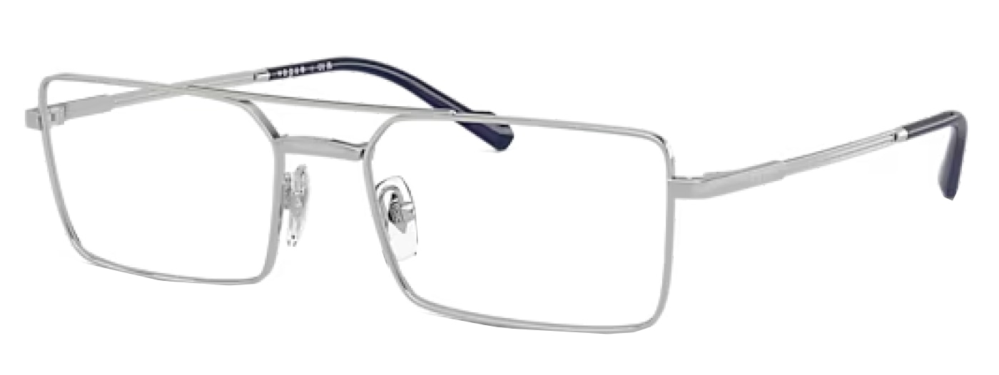 A pair of large silver rectangular Vogue glasses, made of metal with a double-bridge design. The nose pads are transparent and the brand logo is just visible along the temples.