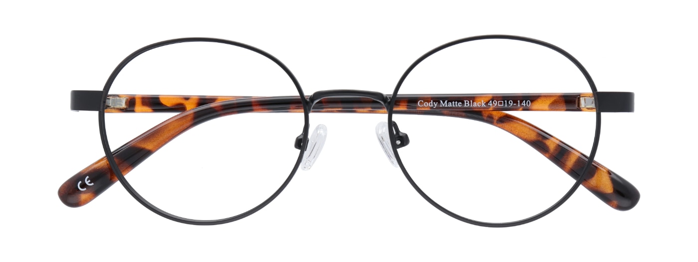 A pair of round metal glasses in matte black with tortoiseshell acetate temples. The glasses are folded up. 