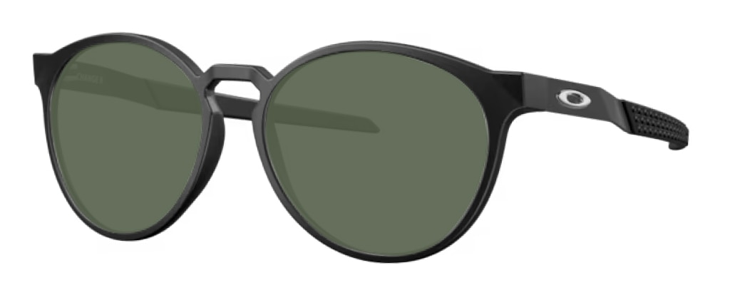 Large round Oakley frames made of plastic with green lenses, positioned at an angle. The iconic O logo is visible along the temples and the frames have a large keyhole bridge. 