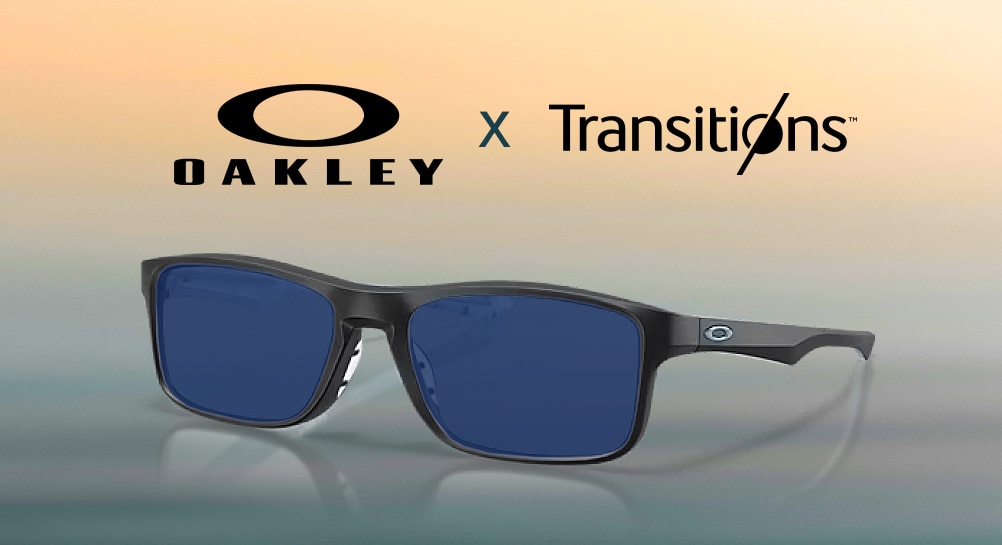 Black rectangular Oakley sunglasses with blue-tinted lenses displayed against a yellow-to-blue gradient backdrop, with the Oakley and Transitions logos positioned above.
