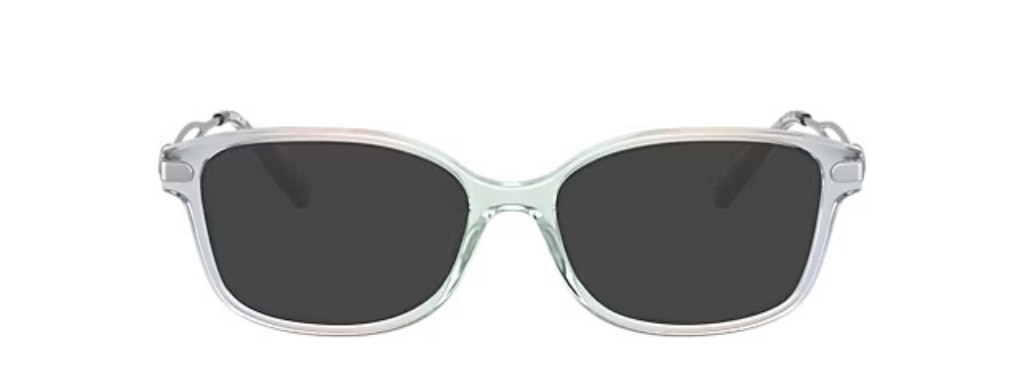 Rectangular acetate sunglasses in gradient, transparent blue. They have silver metal arms, embellished with the 'C' emblem for Coach.