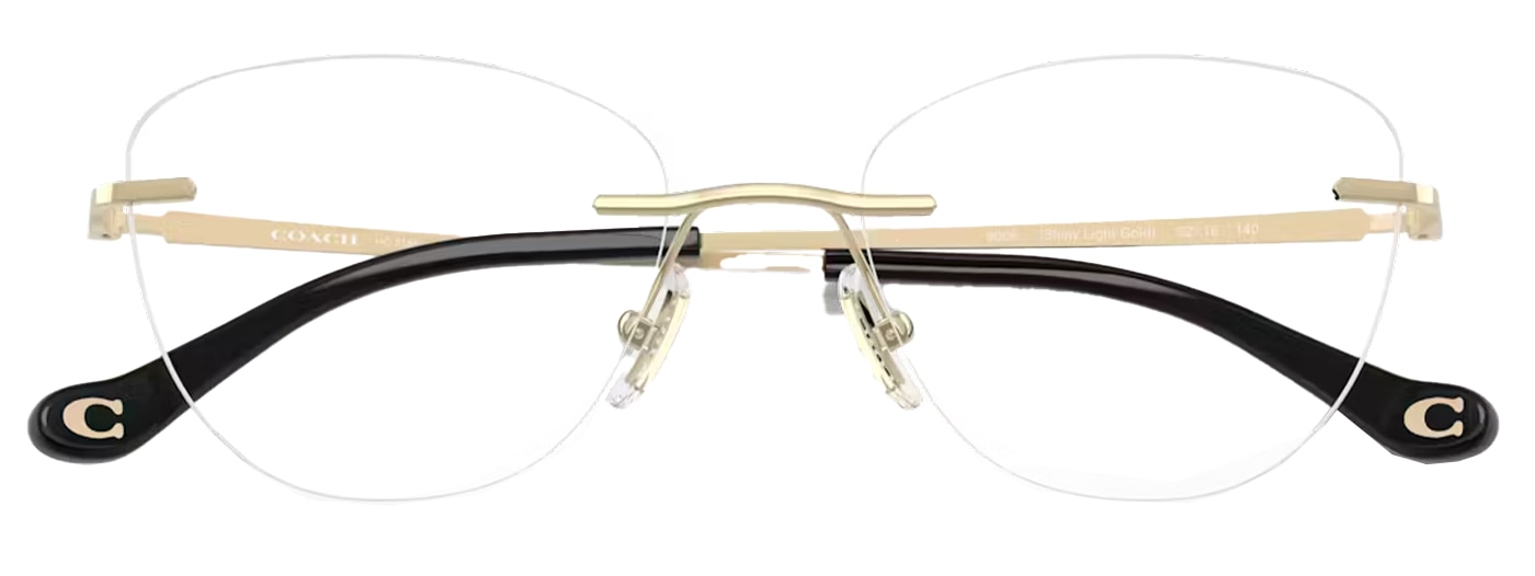 Folded Coach rimless gold cat-eye glasses with rubber nose pads and black plastic branded temple tips.