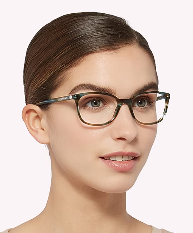 Woman with her light brown hair swept back wearing Tiffany & Co square ocean turquoise acetate glasses against a neutral background.