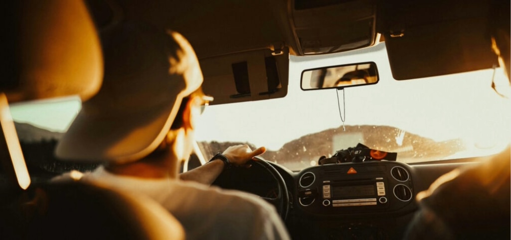 Bright low sun causing glare while driving, both sun visors lowered.