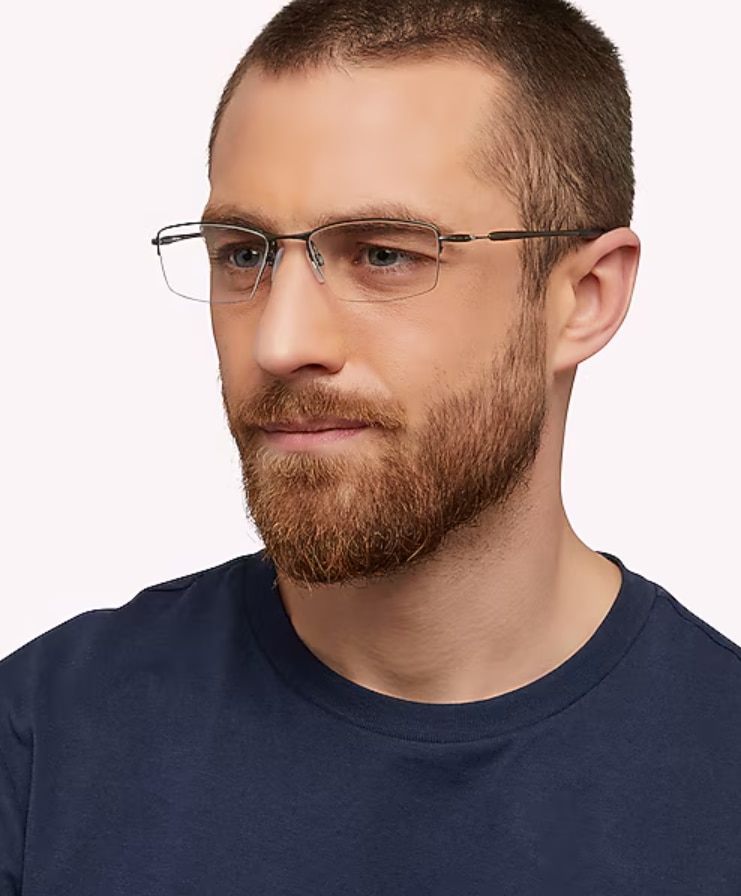 Man with short brown hair and a beard wearing Oakley® Lizard™ titanium pewter semi-rimless rectangular frames with adjustable nose pads.