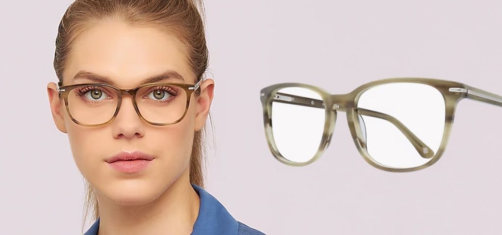 A close-up of a young lady with green eyes and long blonde hair tied back in a ponytail. She is wearing a pair of khaki green, circular acetate glasses and a blue shirt. The same glasses are displayed closer up at an angle next to her.