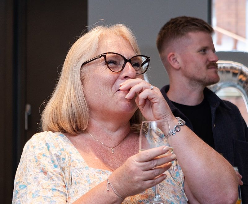 Close-up of female laughing amongst colleagues