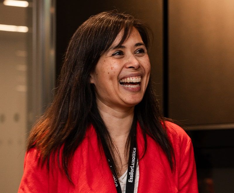 Close-up of female laughing amongst colleagues