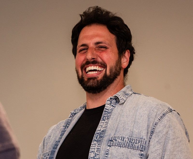 Close-up of male laughing amongst colleagues