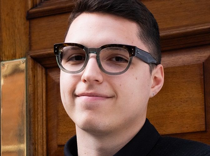 Smiling man wearing Ray-Ban RB0298V glasses