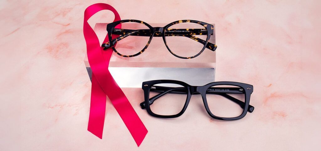 Two pair of frames on resting a clear block and one just below with a pink RIbbon position next to the frames all on a light pink background