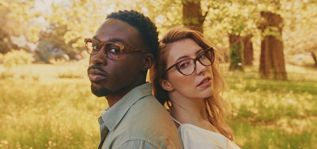 Young couple, one male and one female wearing frames from the Field of Barley collection