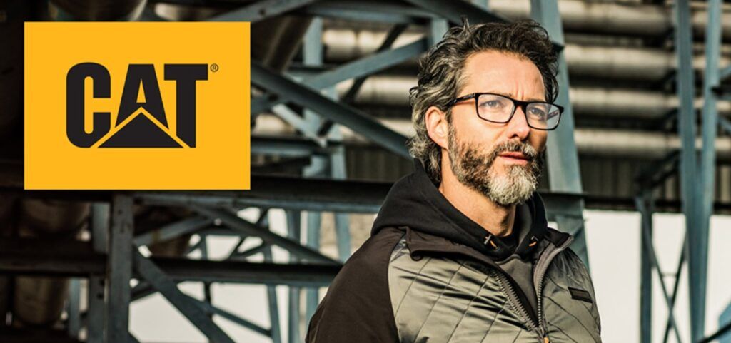 Caterpillar logo placed on left corner of an older male with a beard wearing Caterpillar frames