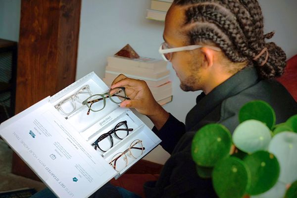 Perri Kiely looking at four frames in a Glasses Direct Home Trial box