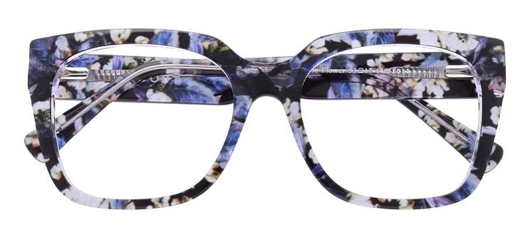 A chunky, square acetate frame with a blue, black and white flower pattern