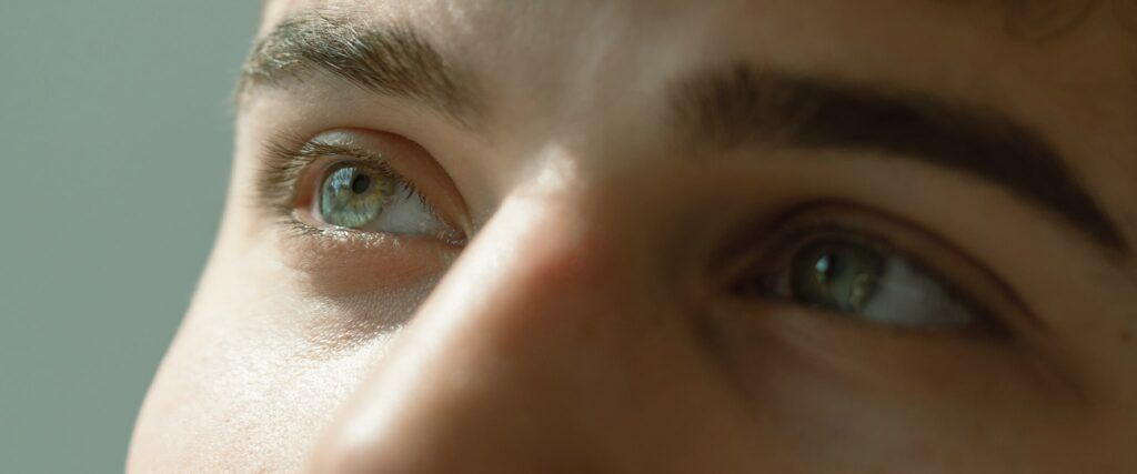 Close-up of male with green eye look to the left