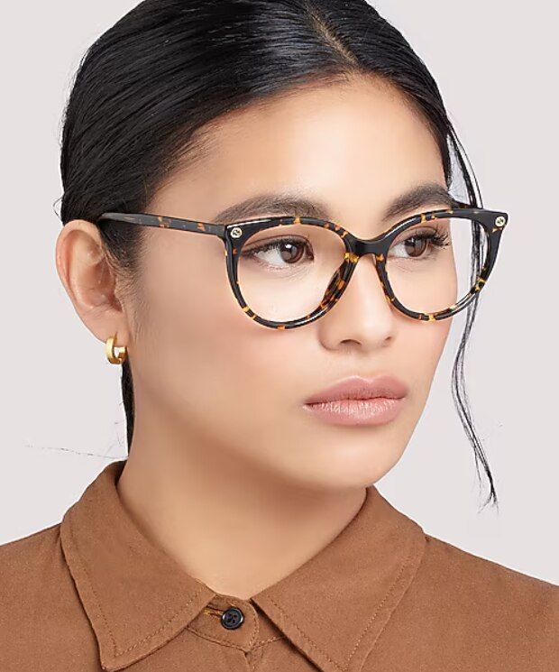 Woman with dark hair wearing round tortoiseshell glasses with a low-bridge fit, designed for improved comfort, stability, and cheek clearance.