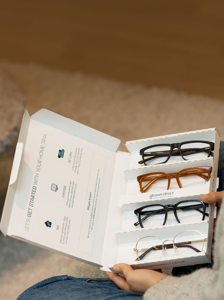 An open Home Trial box revealing four stylish frames inside