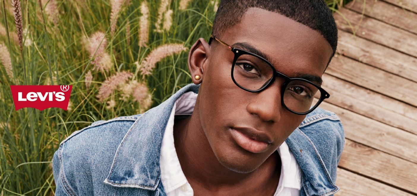 Young man wearing a pair of rectangular Levi's frames outdoors