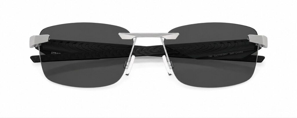 Oakley® Steakhouse 1.0 90s-inspired rimless rectangular metal glasses with thick sculpted black plastic temples, folded up against a plain white background, inspired by 90s-chic fashion.