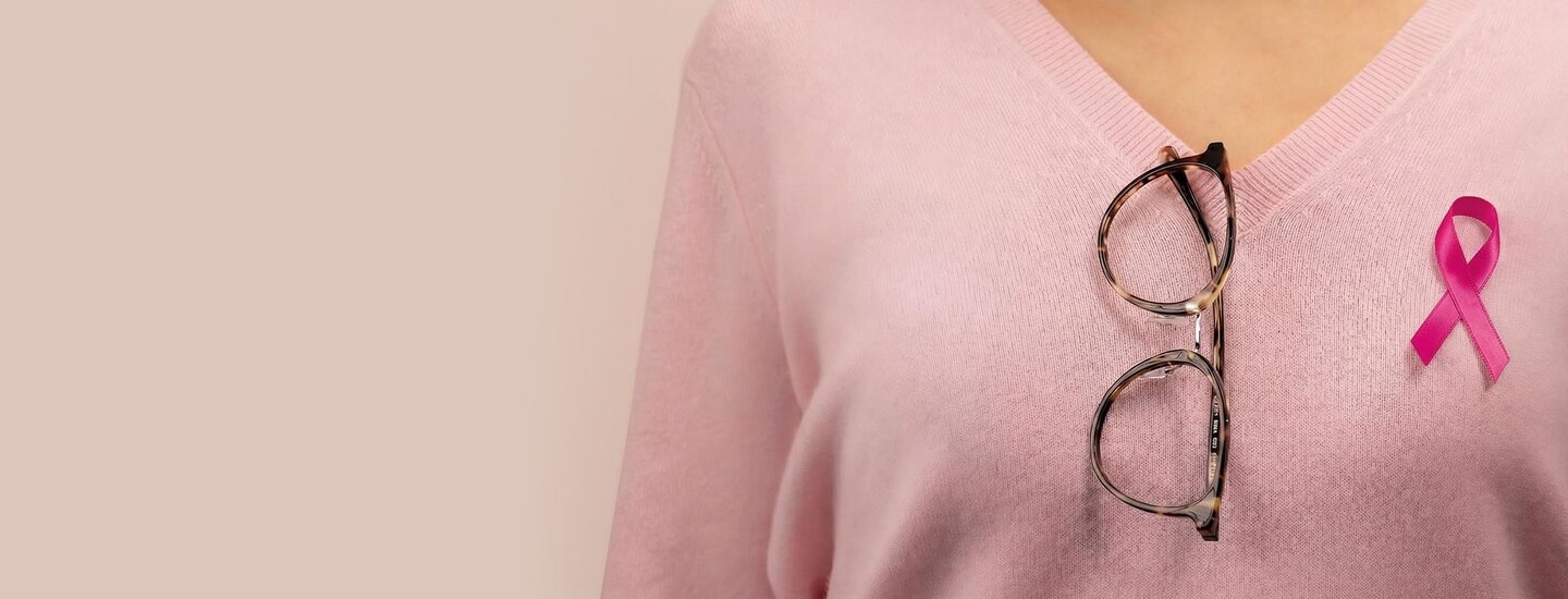 Pair of Pink Ribbons frames hanging from woman's jumper