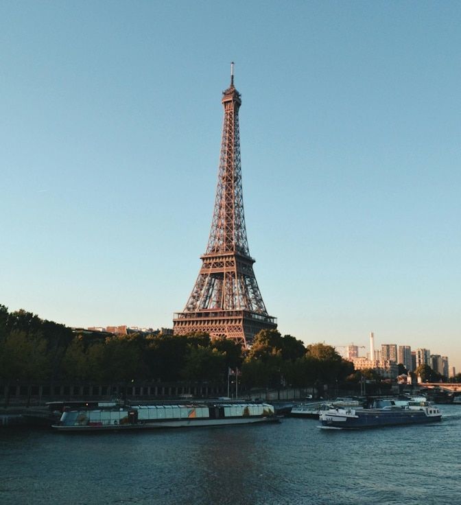 The Eiffel Tower with the Seine and some ships visible next to it