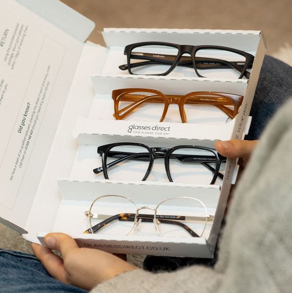 An open Home Trial box revealing four stylish frames inside