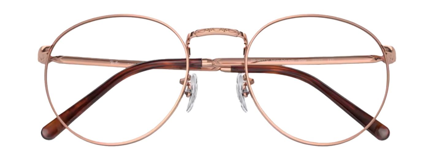 A rose-gold metal phantos frame with rubber nose pads and tortoiseshell temples. It is folded up and the nose bridge is engraved.