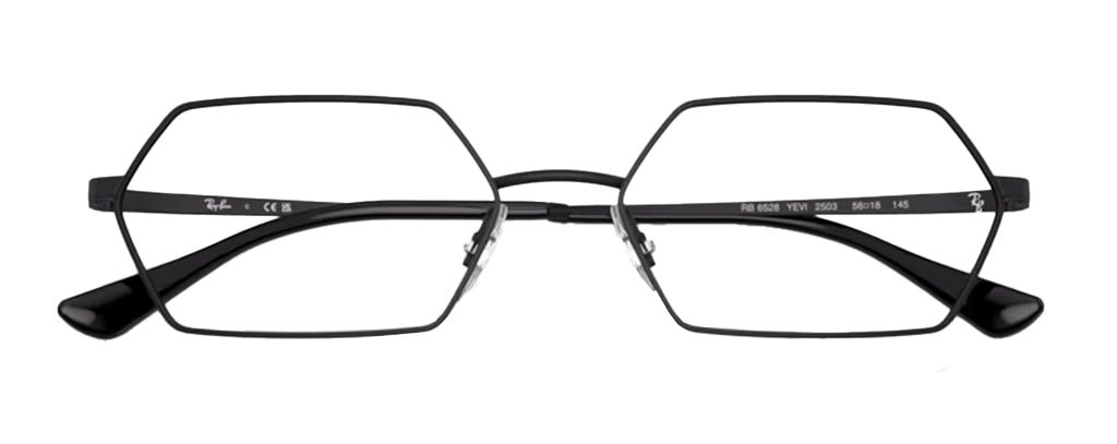 A slim pair of metal hexagonal glasses folded up. The frame is a dark black and it has clear rubber nose pads along with black acetate tips.