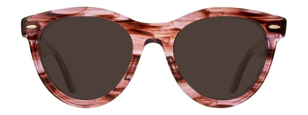 An oversized pair of Wayfarer sunglasses stripy transparent pink plastic frame, featuring sleek metal rivets.