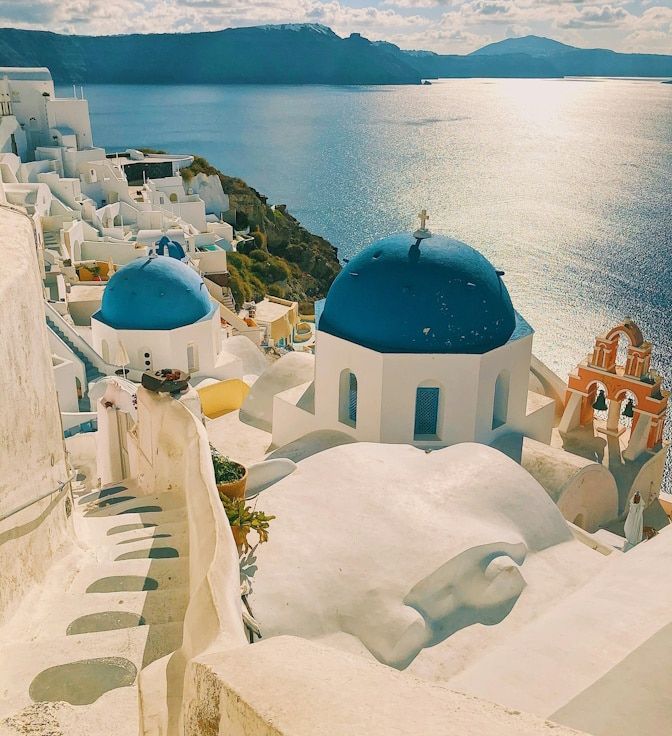 View of a town in Santorini from above, also showing the adjacent blue sea