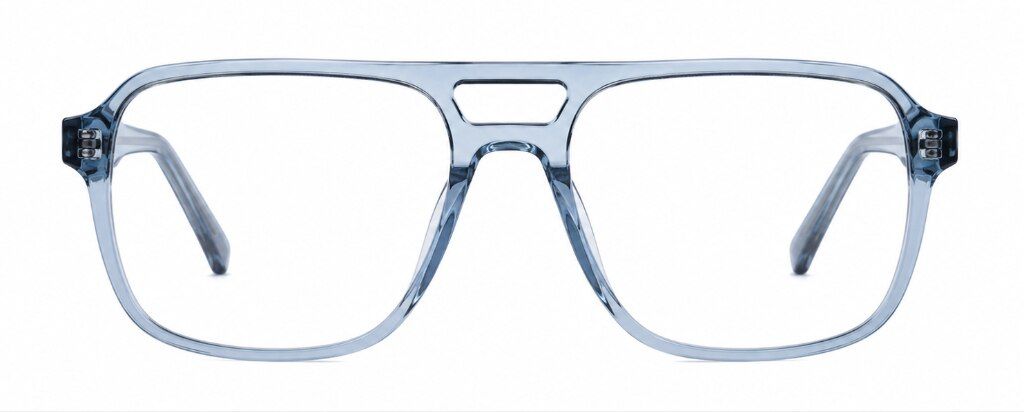 Front-facing view of Scout Michael oversized aviator-style eyeglasses with a translucent crystal-blue acetate frame. The frame features large squared lenses, a bold double bridge and a contemporary geometric silhouette. Visible temple arms behind the lens