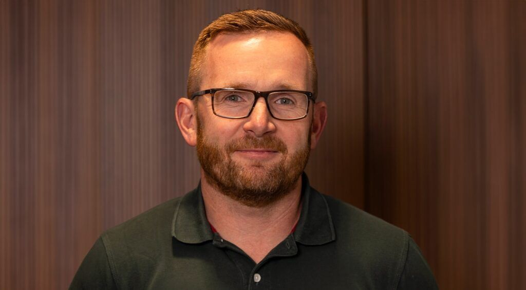 Male wearing square brown frames