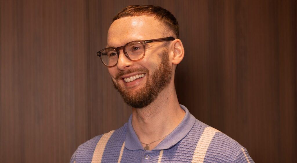 Male wearing round brown frames