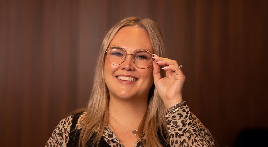 Female wearing round, gold metal frames