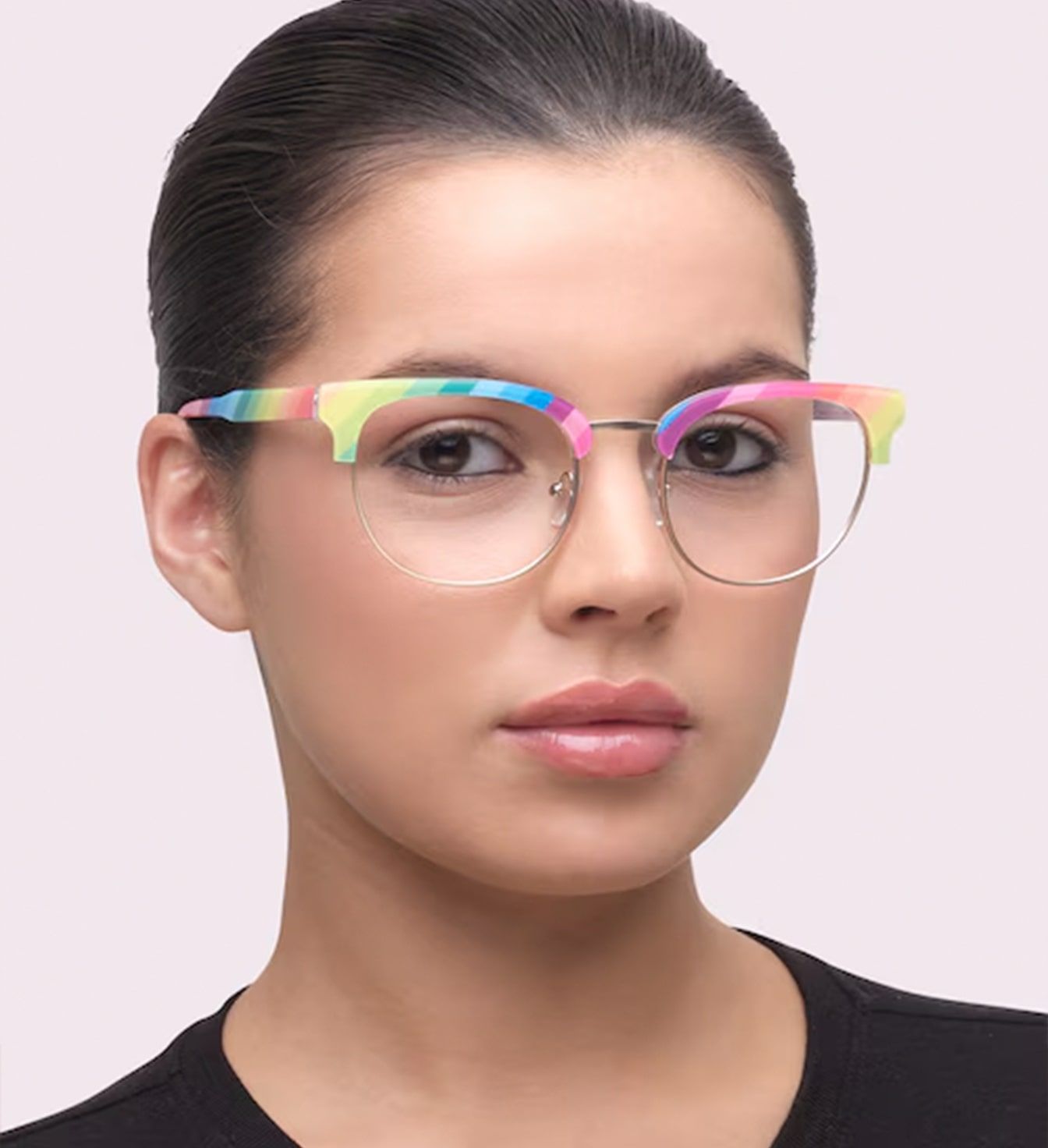 A young lady with dark hair tied neatly back. She is wearing a rainbow-coloured Clubmaster frame made of acetate and metal.