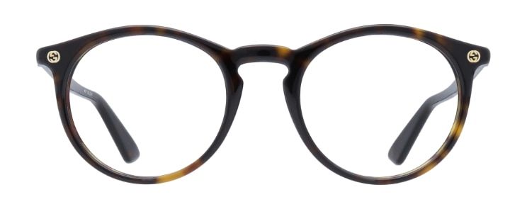 A Gucci oval frame made of acetate with a keyhole bridge. It comes in a dark tortoise print and features the brand icon in gold on the corner of the temples.