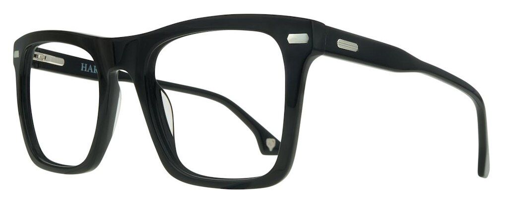 A close up of a large pair of square glasses made from thick black acetate with silver rivets.