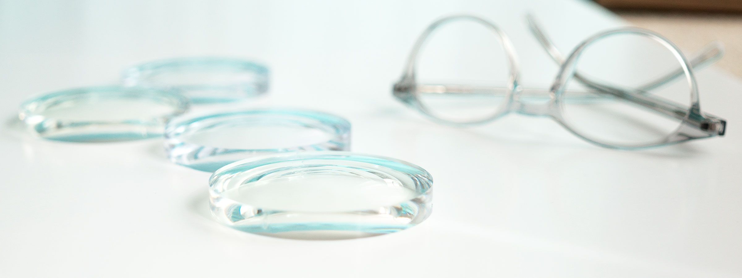 Glasses lenses lying next to a frame