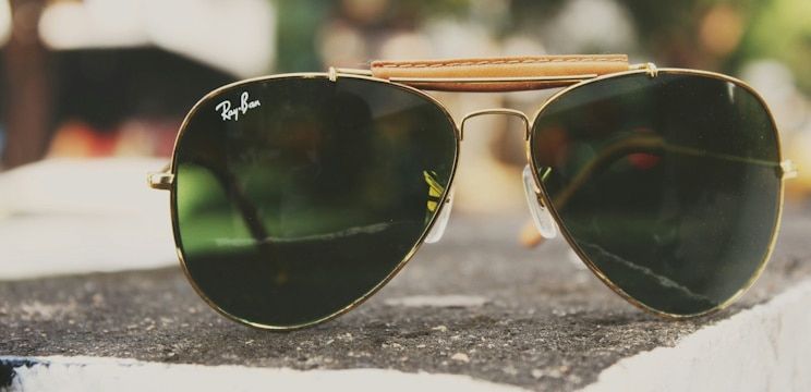 Close-up of a pair of Ray-Ban aviator sunglasses with the plastic nose pads clearly visible