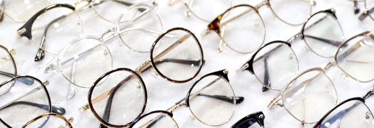 A large number of glasses frames laid out to be inspected