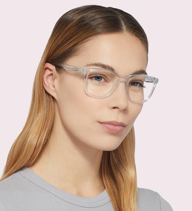 A woman with long, straight hair wearing Oakley Trillbe glasses