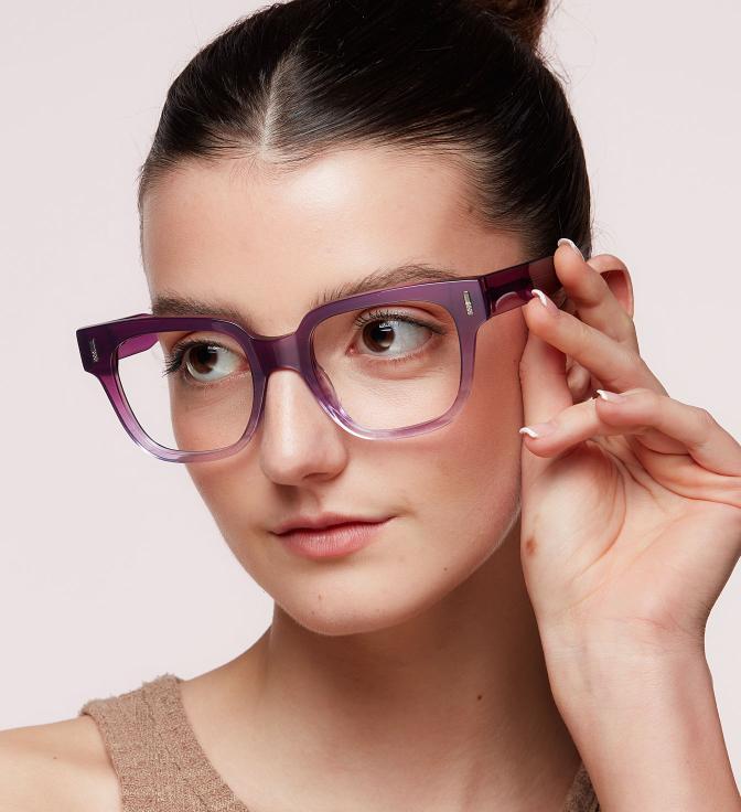 A woman with her hair in a tight bun wearing Scout Jenny glasses